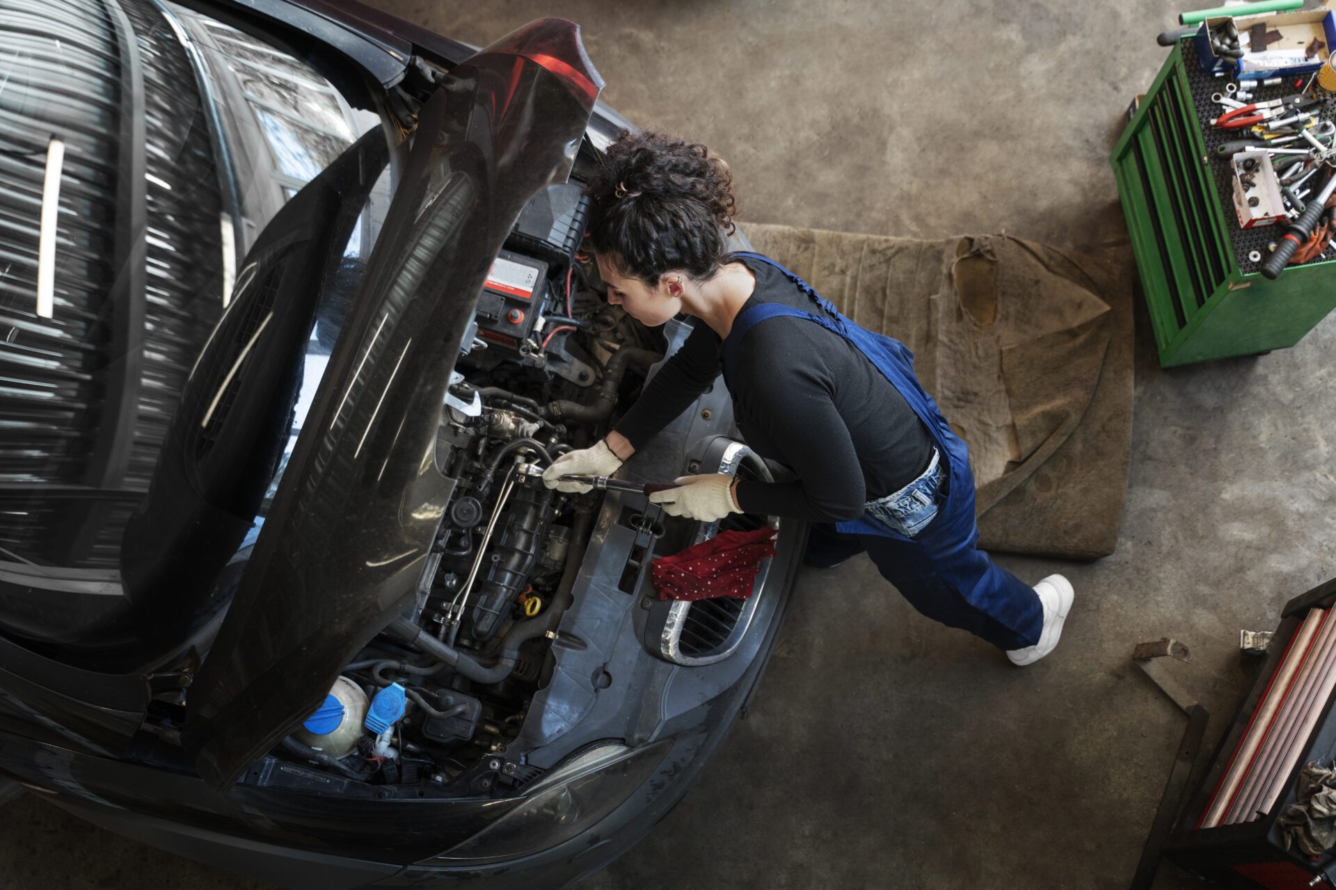 Top view woman repairing car