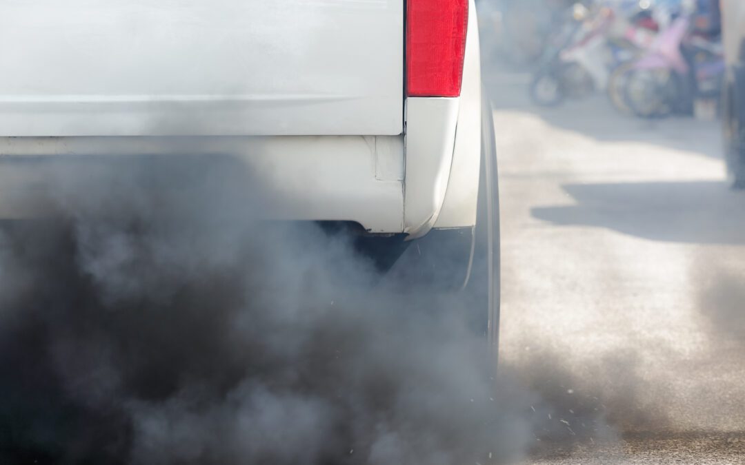 Air pollution from vehicle exhaust pipe on the road.