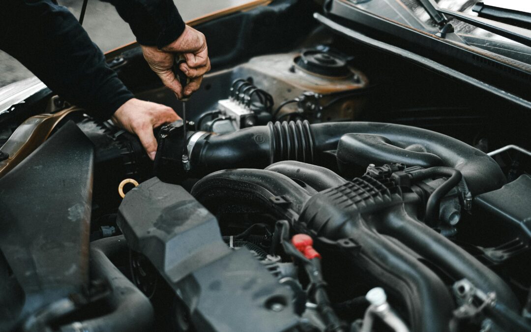 A car technician repairs a car engine.